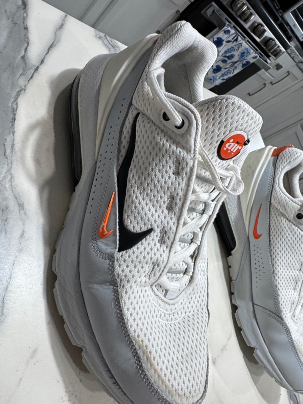 Nike Men’s White Sneakers with Black and Orange Swooshes